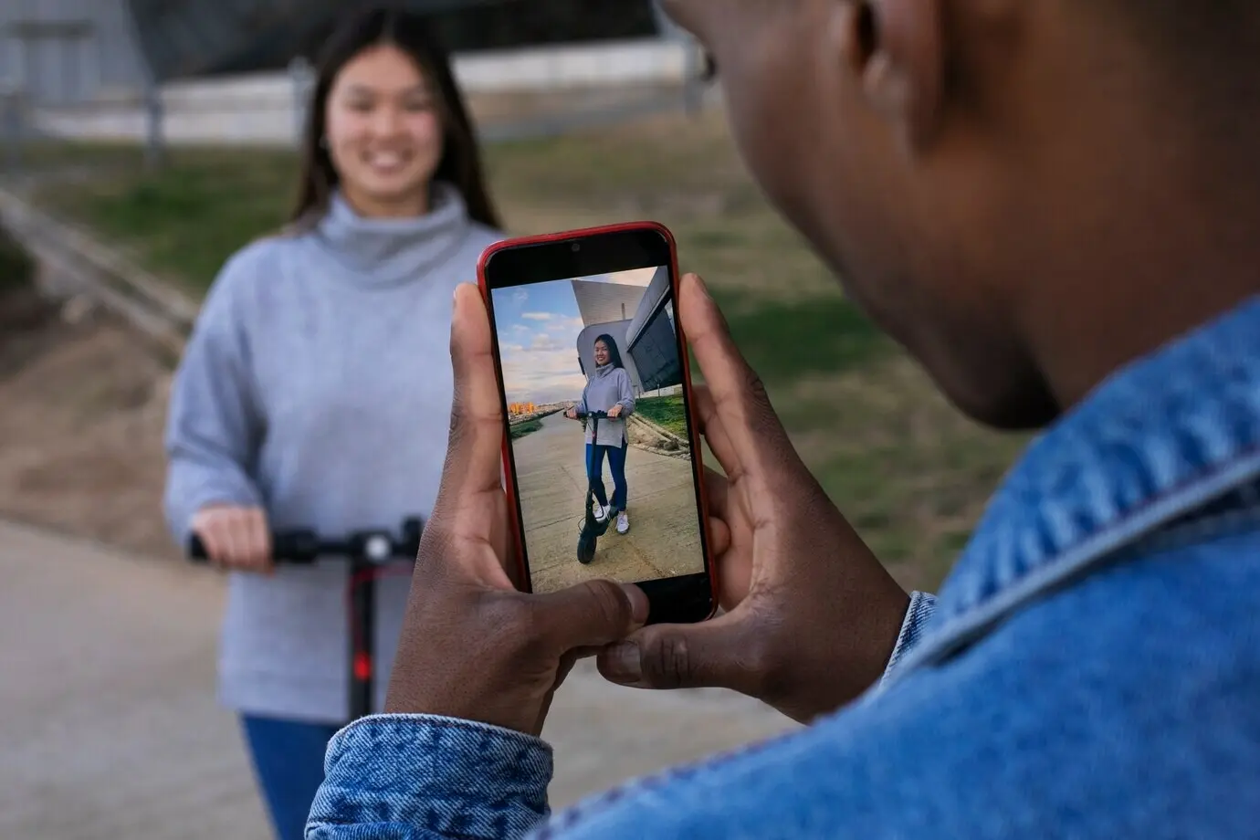A couple riding an electric scooter as a means of transportation.